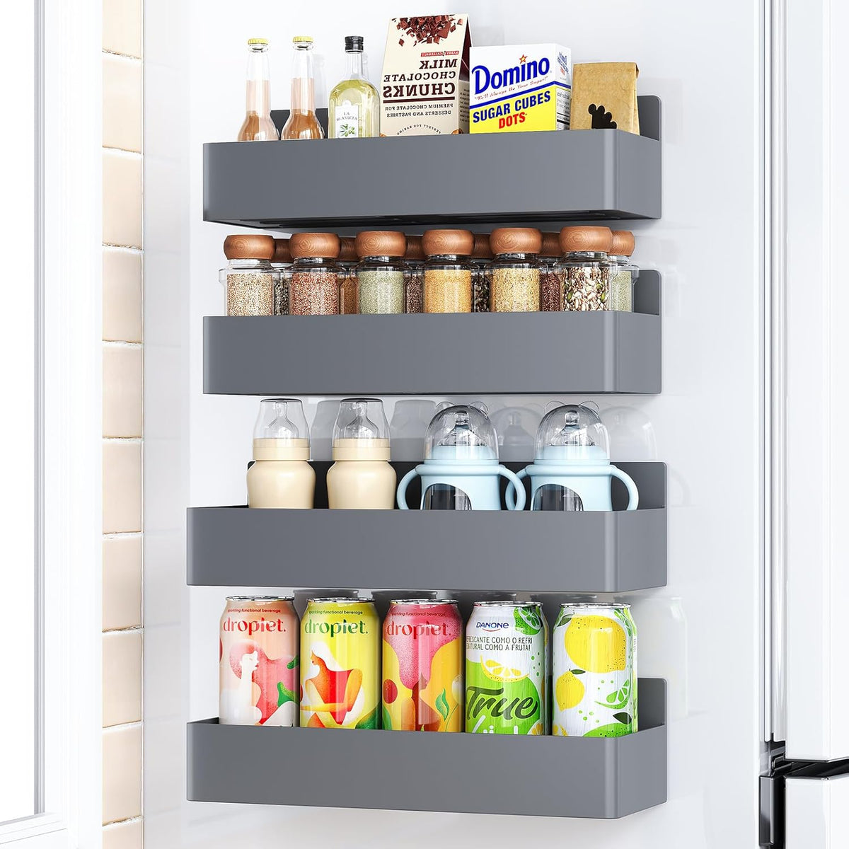 Magnetic spice rack mounted on the side of a refrigerator holding spice jars.