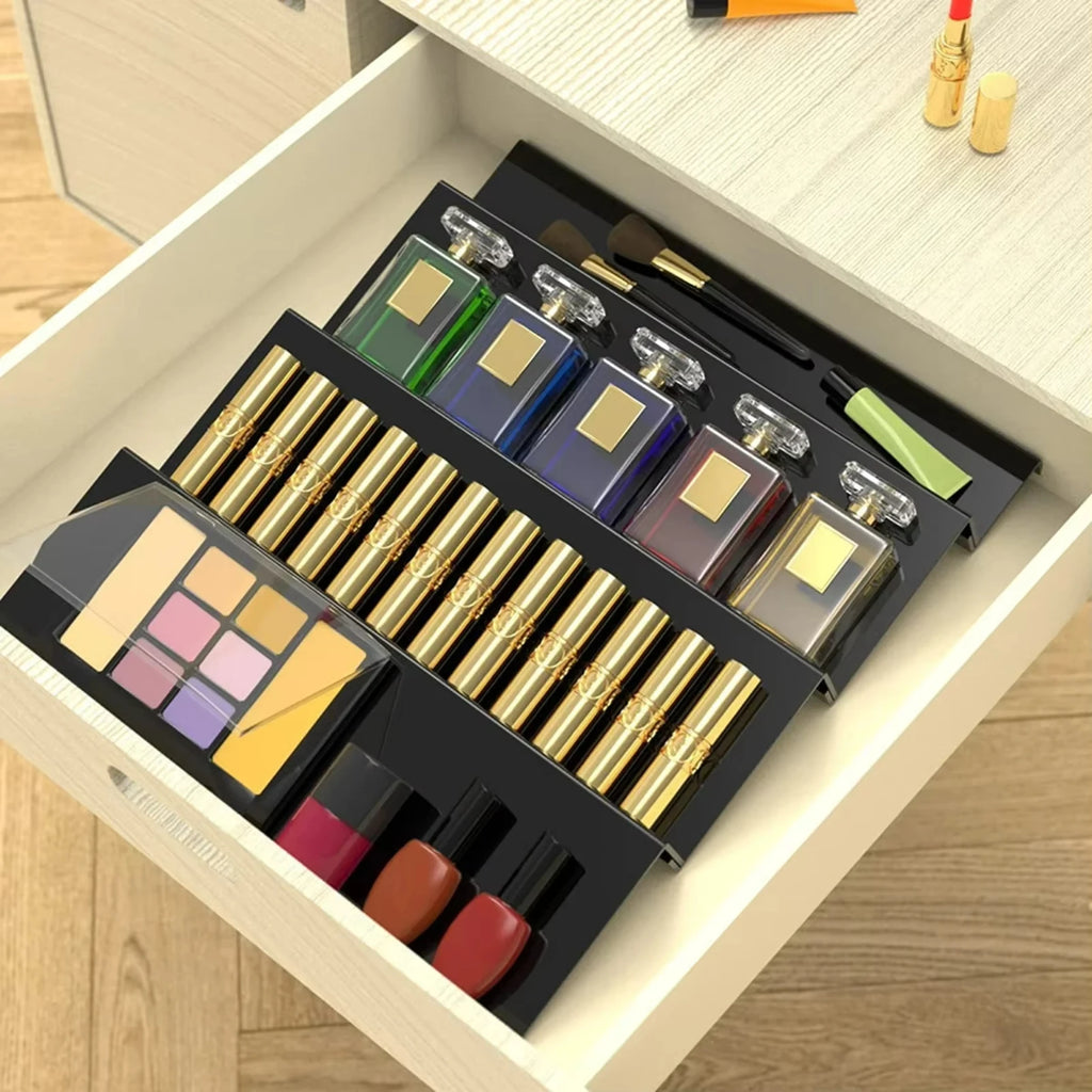 Adjustable acrylic spice organizer tray inside an open kitchen drawer holding spice jars at an angle.