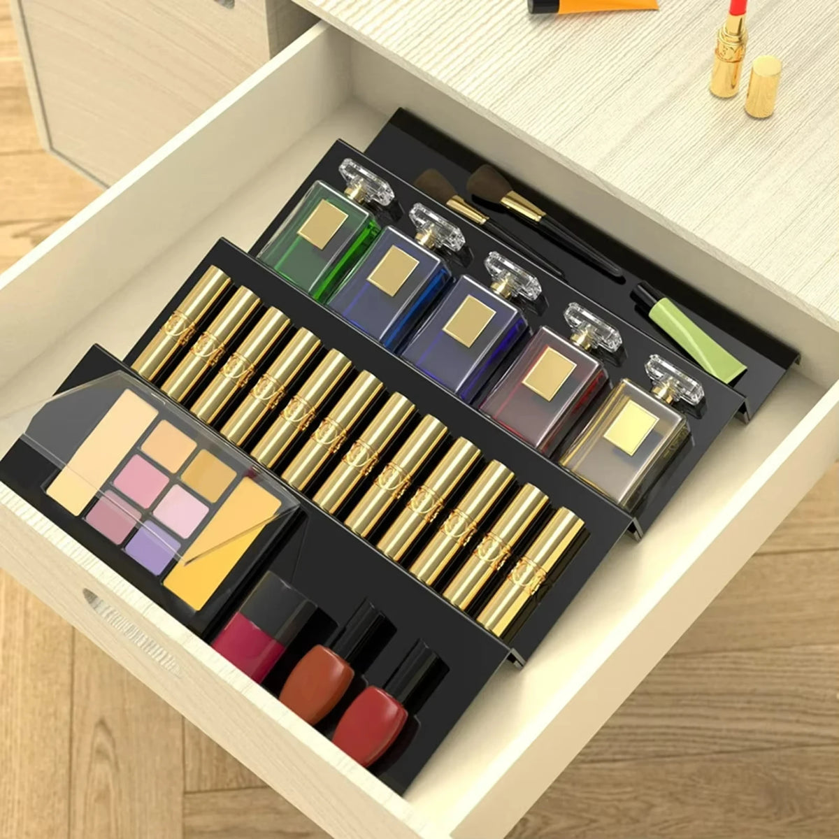 Adjustable acrylic spice organizer tray inside an open kitchen drawer holding spice jars at an angle.
