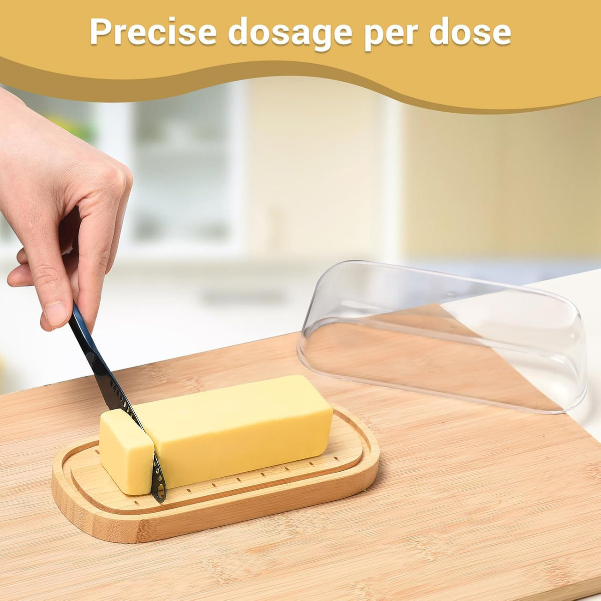 Bamboo butter dish with lid holding a stick of butter on a kitchen counter.