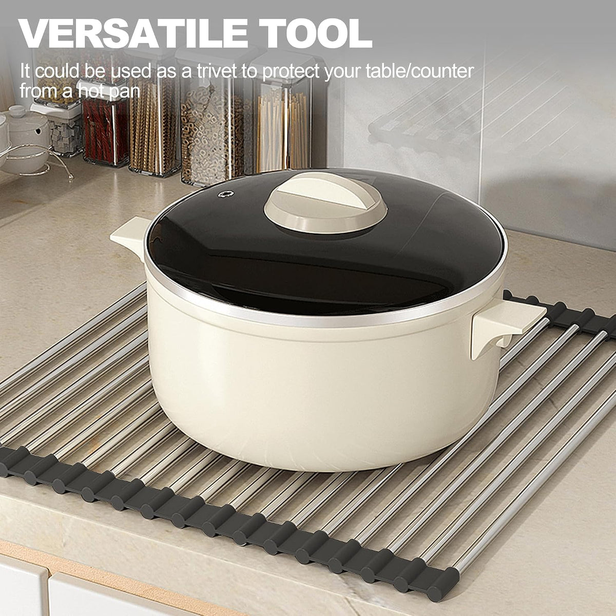 Black roll-up dish drying rack draped over a kitchen sink with dishes drying above it.