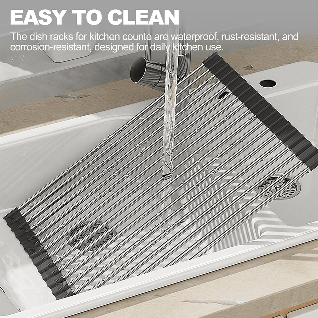 Black roll-up dish drying rack draped over a kitchen sink with dishes drying above it.