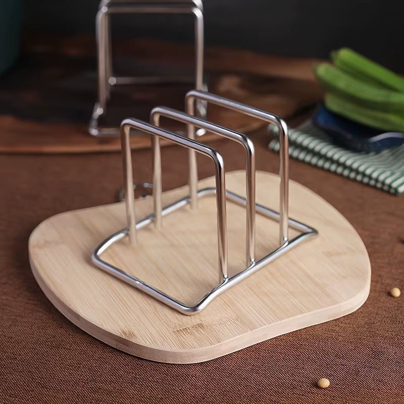 Stainless steel countertop rack organizing pot lids and cutting boards side by side.
