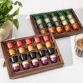 Two acacia wood coffee pod holder trays displayed on a kitchen countertop coffee bar.