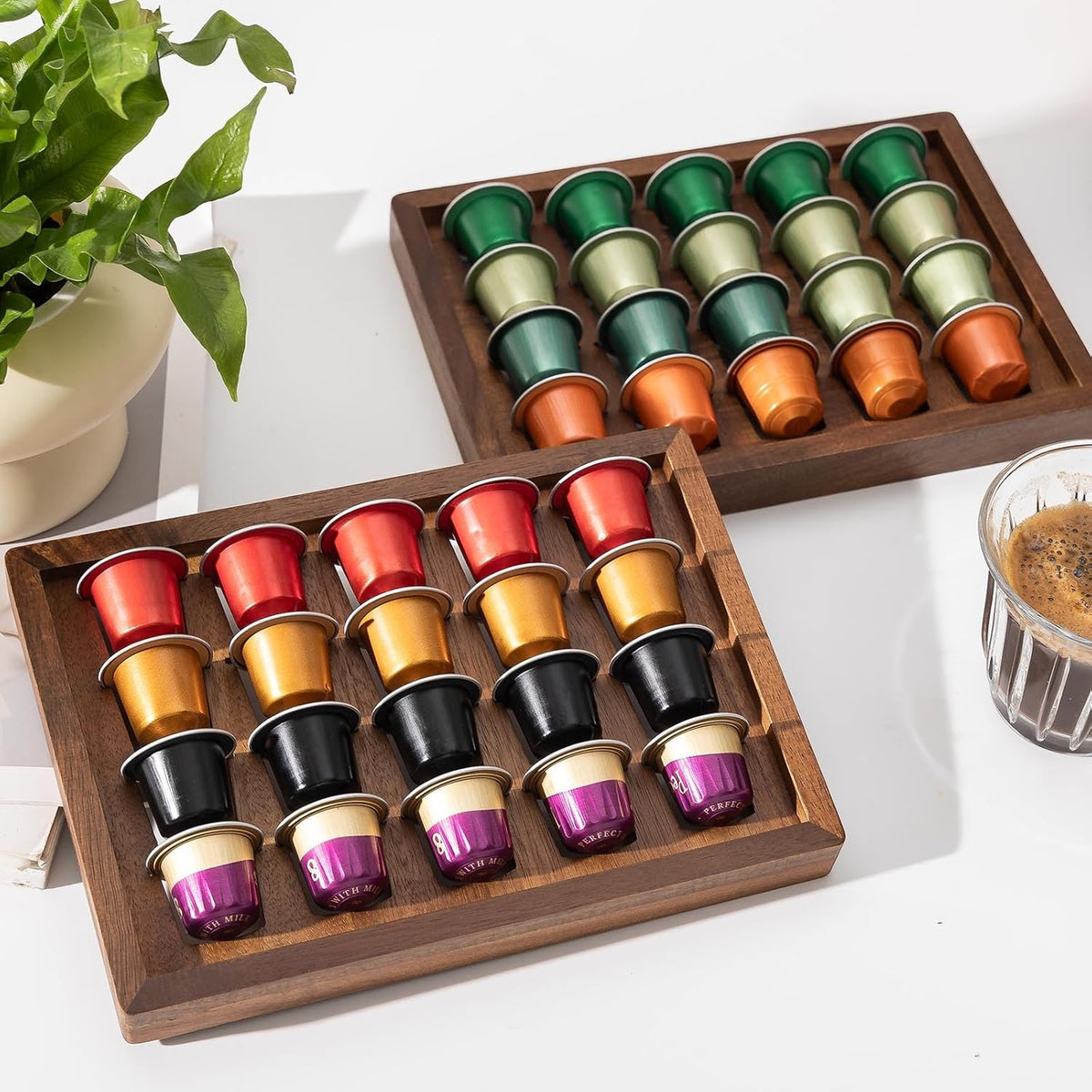 Two acacia wood coffee pod holder trays displayed on a kitchen countertop coffee bar.