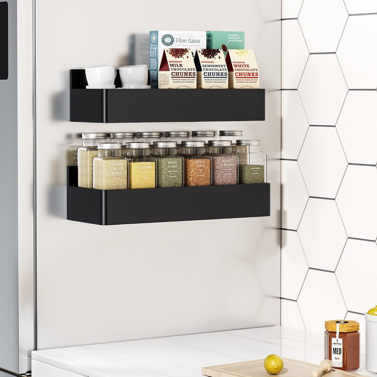 Magnetic spice rack mounted on the side of a refrigerator holding spice jars.