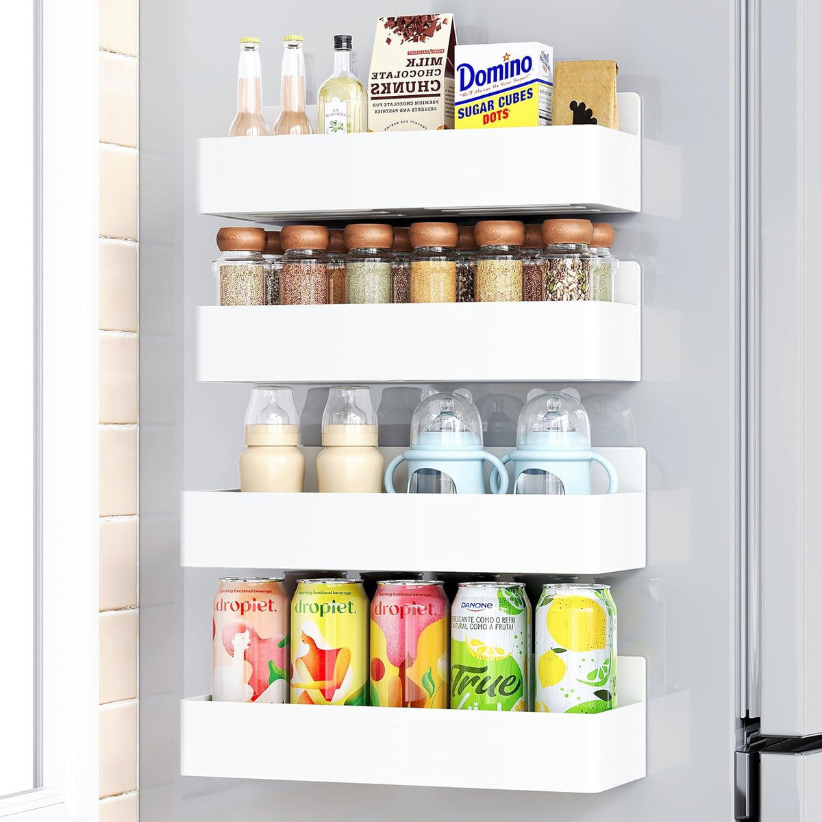 Magnetic spice rack mounted on the side of a refrigerator holding spice jars.