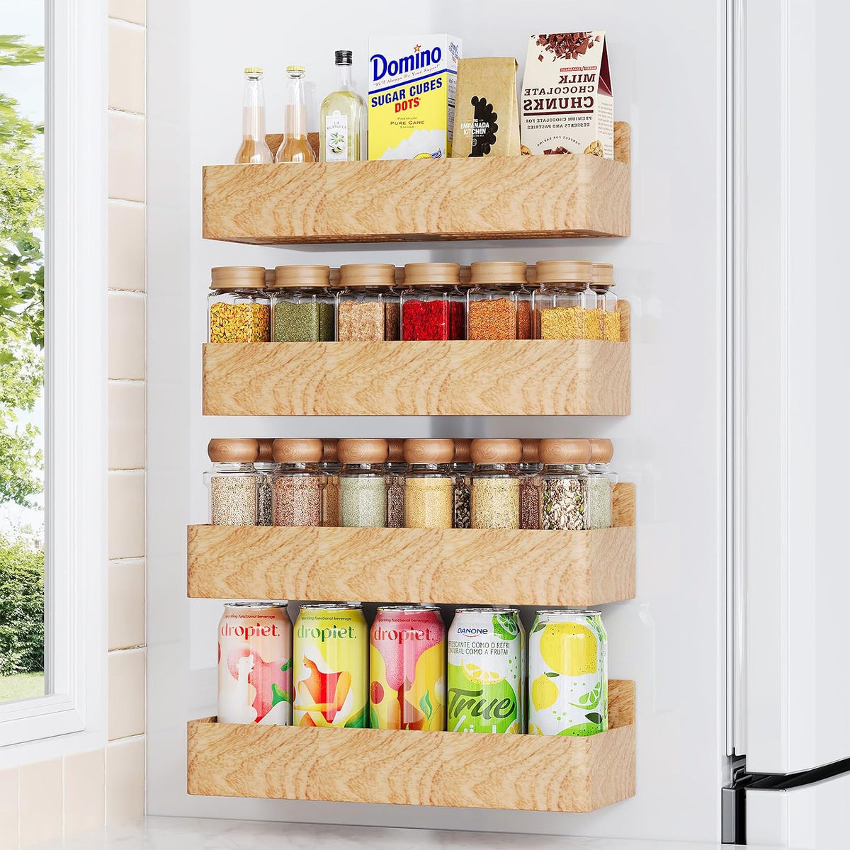 Magnetic spice rack mounted on the side of a refrigerator holding spice jars.