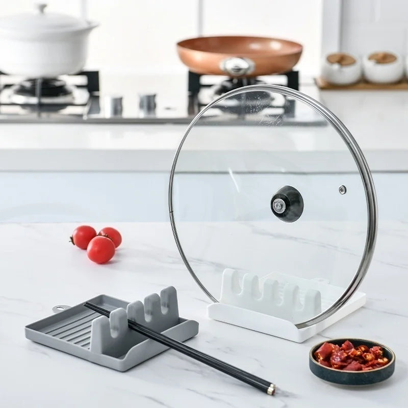 Non-slip kitchen utensil holder resting a spoon and spatula on a countertop.