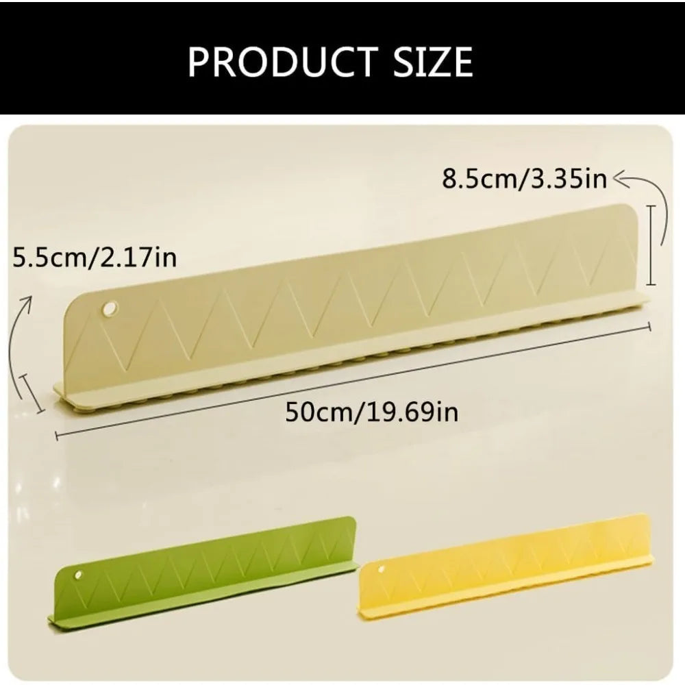 Silicone sink splash guard attached to the edge of a kitchen sink with suction cups.