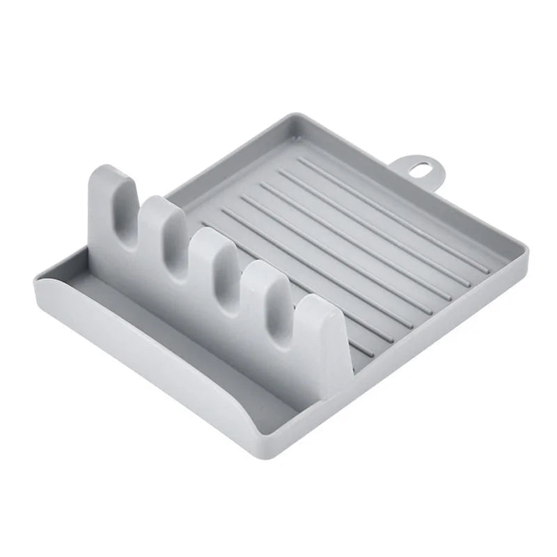 Non-slip kitchen utensil holder resting a spoon and spatula on a countertop.