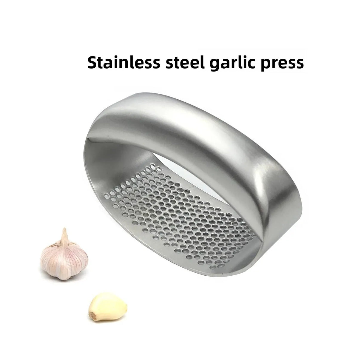 Stainless steel manual garlic press held over a cutting board with minced garlic.