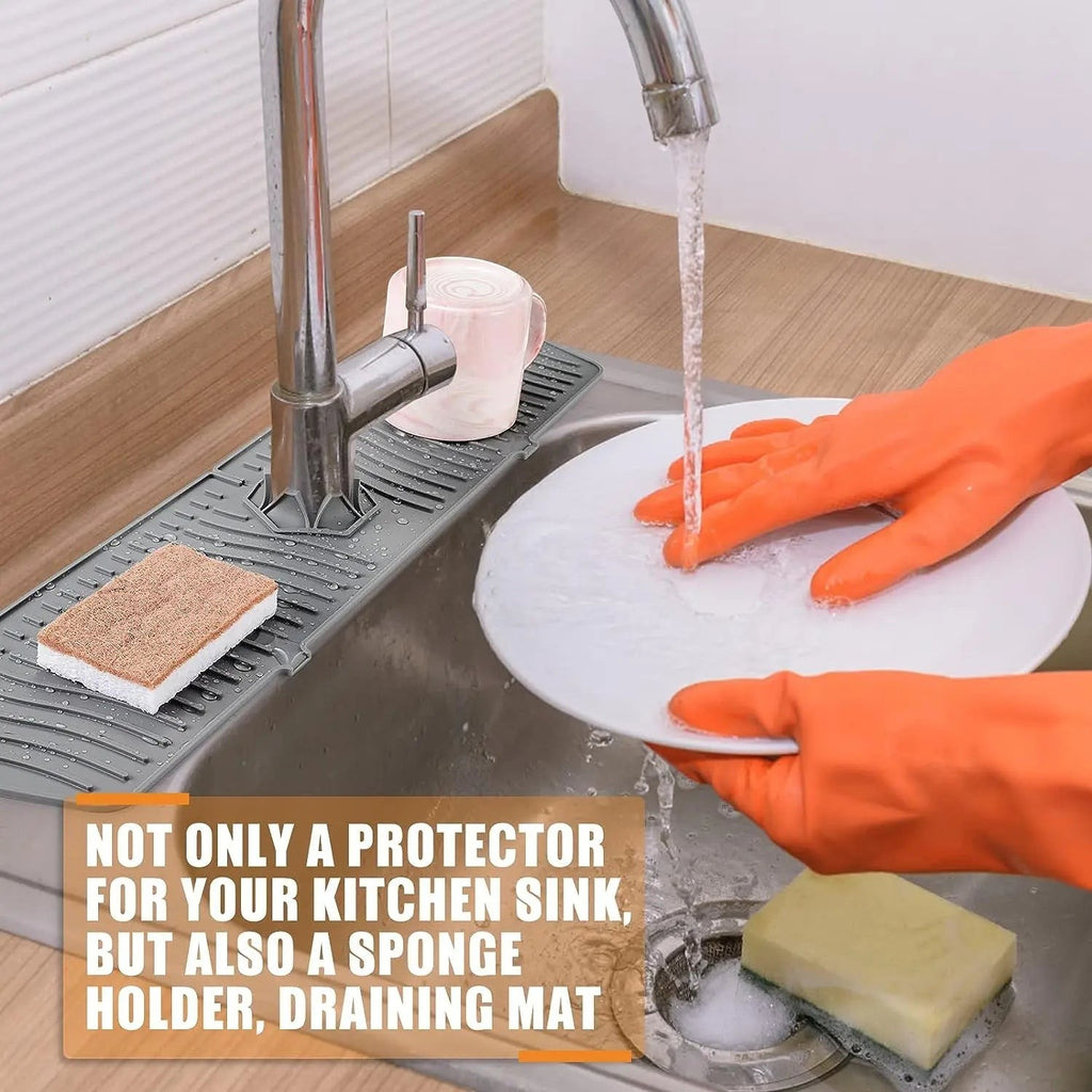Silicone faucet splash guard mat placed around the base of a kitchen faucet.