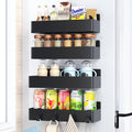 Magnetic spice rack mounted on the side of a refrigerator holding spice jars.