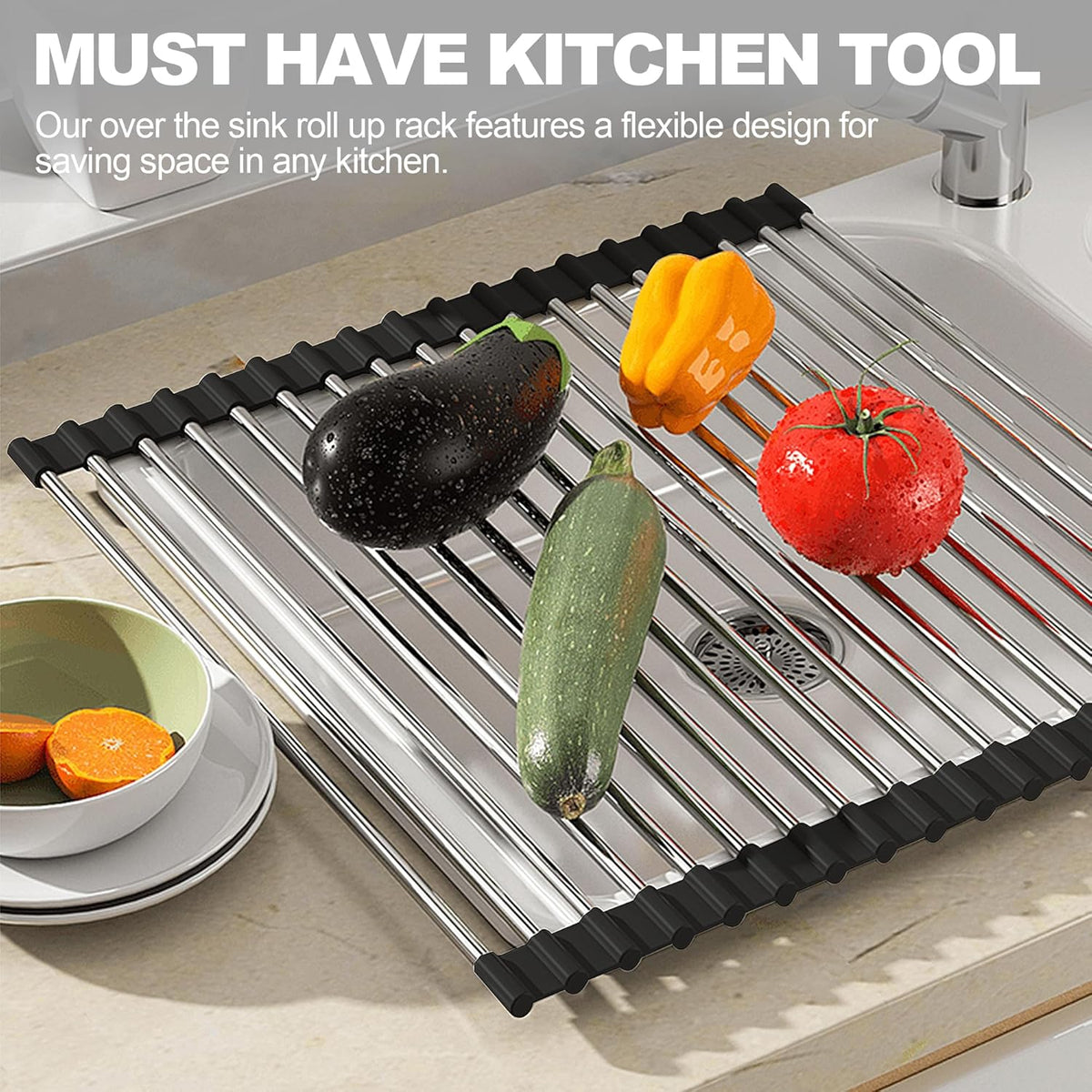 Black roll-up dish drying rack draped over a kitchen sink with dishes drying above it.