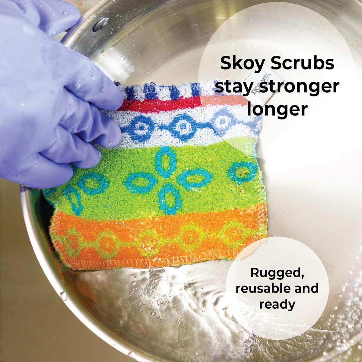 Set of four reusable non-scratch dish scrubbers in assorted colors on a kitchen counter.