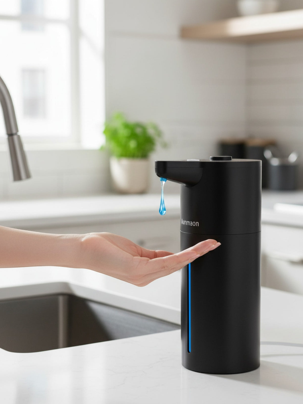 Simpson touchless automatic soap dispenser in matte black with blue LED light dispensing soap into a hand in a kitchen