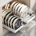 Simpson white pull-out cabinet organizer holding various pots, pans, and lids in adjustable carbon steel slots.